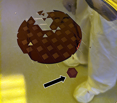 The processed wafer with an arrow pointing to the final microchip.
