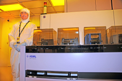 CNF staff alongside the ASML tool in the cleanroom