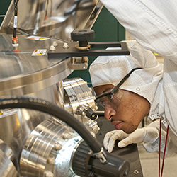 CNF REU intern Austin Little (2014) works with one of the CNF sputtering systems.