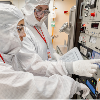 Image of two REU students working in the CNF Cleanroom