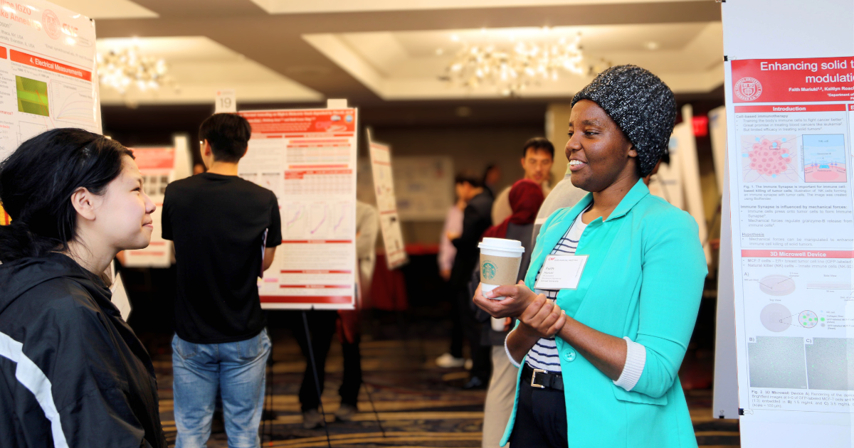 Photo of two individuals chatting at the Annual Meeting Poster Session