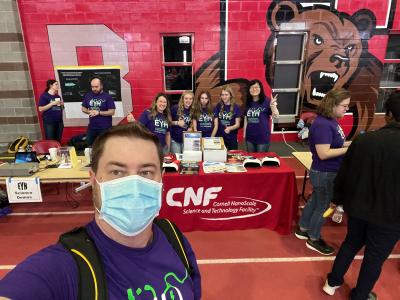 TOm Pennel, Rebecca Vliet, Xinwei Wu, and ambassadors pose for a picture at CNF"s EYH table in Barton Hall in 2023